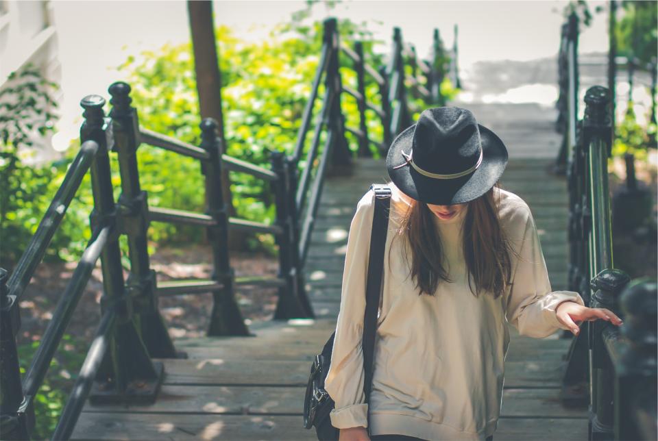 young wood woman steps shirt railing people longhair hat girl fedora fashion clothes brunette bag 