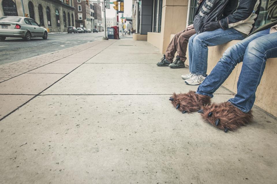urban street slippers sidewalk shoes people pants jeans city 