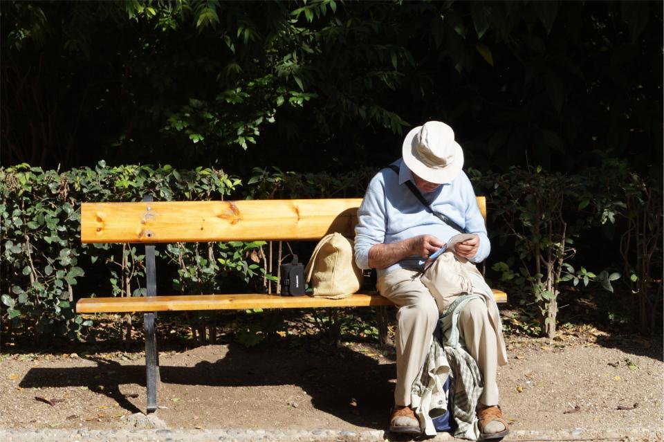 wood sitting reading people old man hat elderly bench 