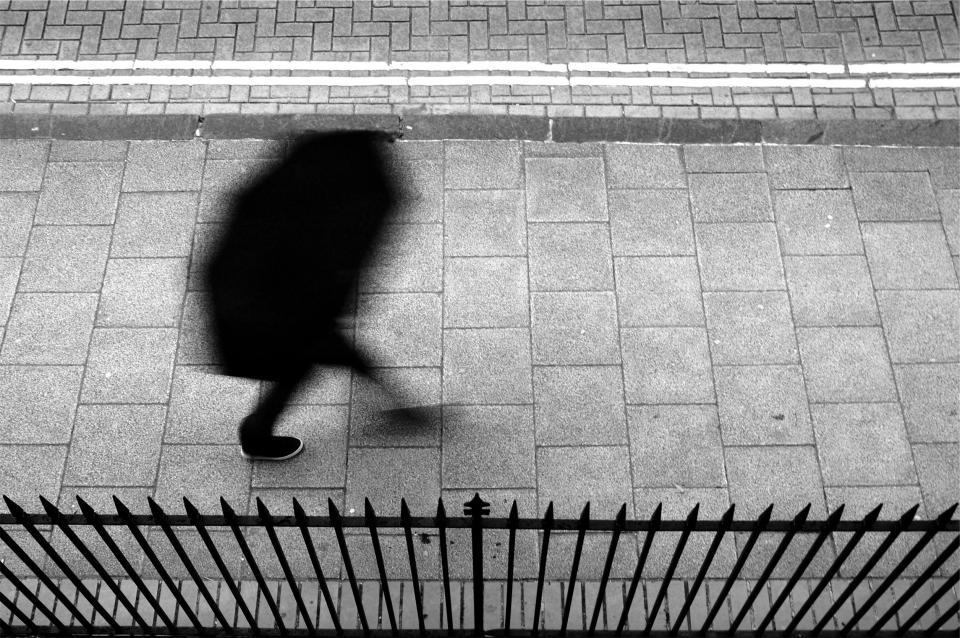 pedestrian, walking, umbrella, sidewalk, fence, people, black and white