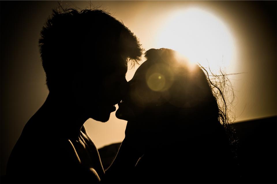 young sunset silhouette shadows romantic romance people love kiss guy girl couple 