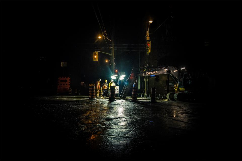 workers trafficlights streets roads night lampposts hardhats equipment deere dark construction city backhoe 