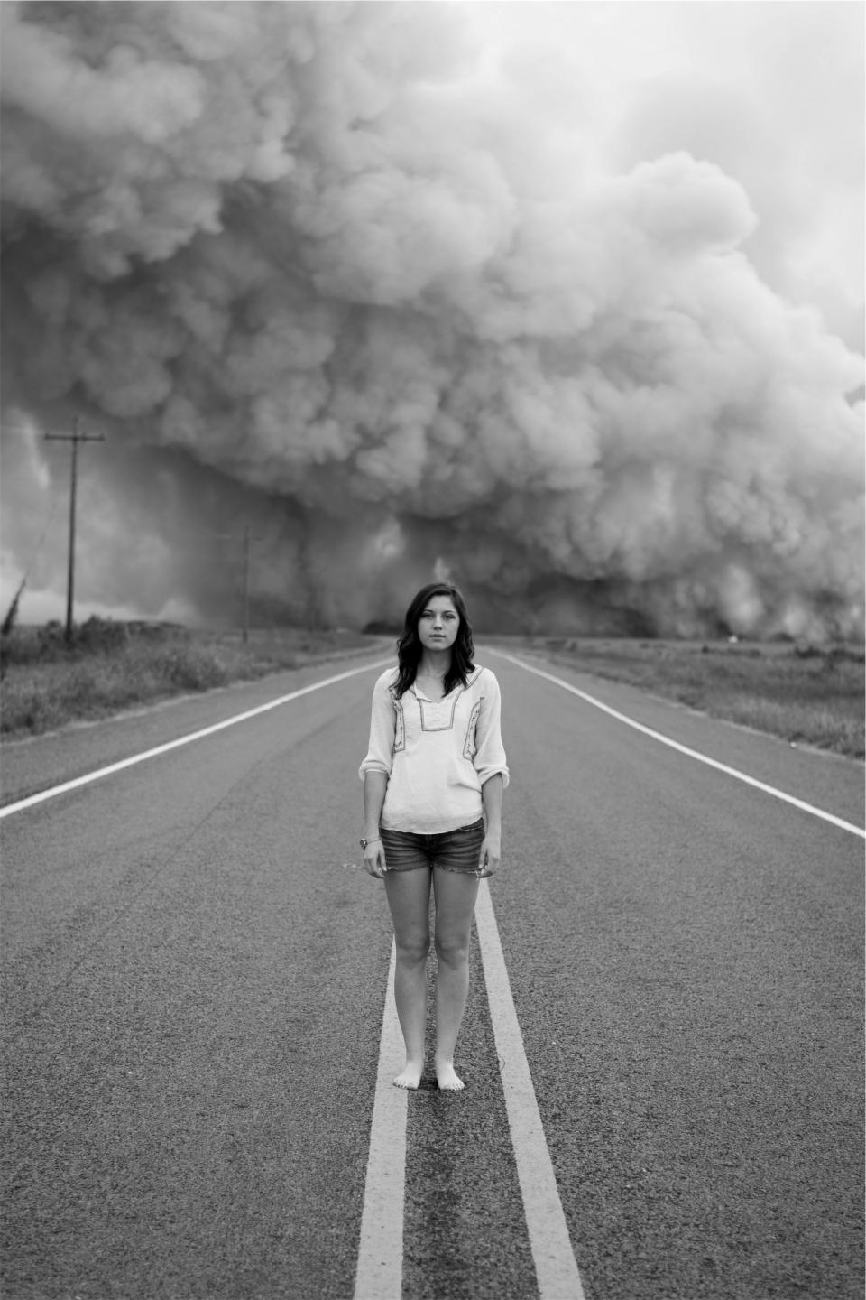 young woman sweater smoke shorts rural road people pavement model longhair girl fashion brunette blackandwhite 