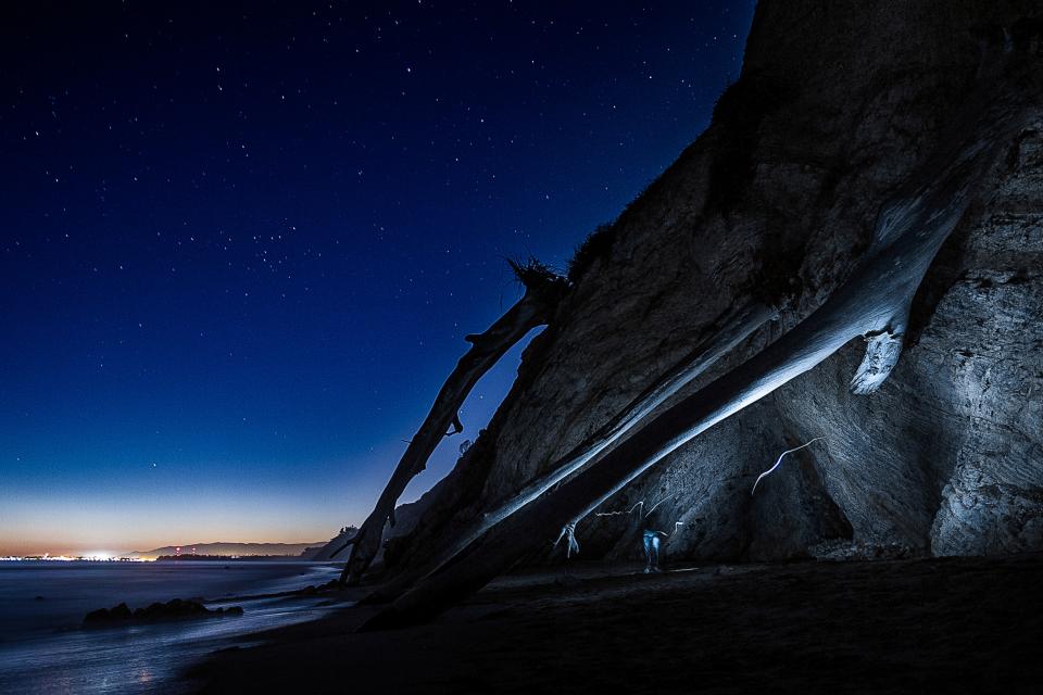 beach, sand, night, shore, dark, sky, stars, lights, rocks, cliffs, cave