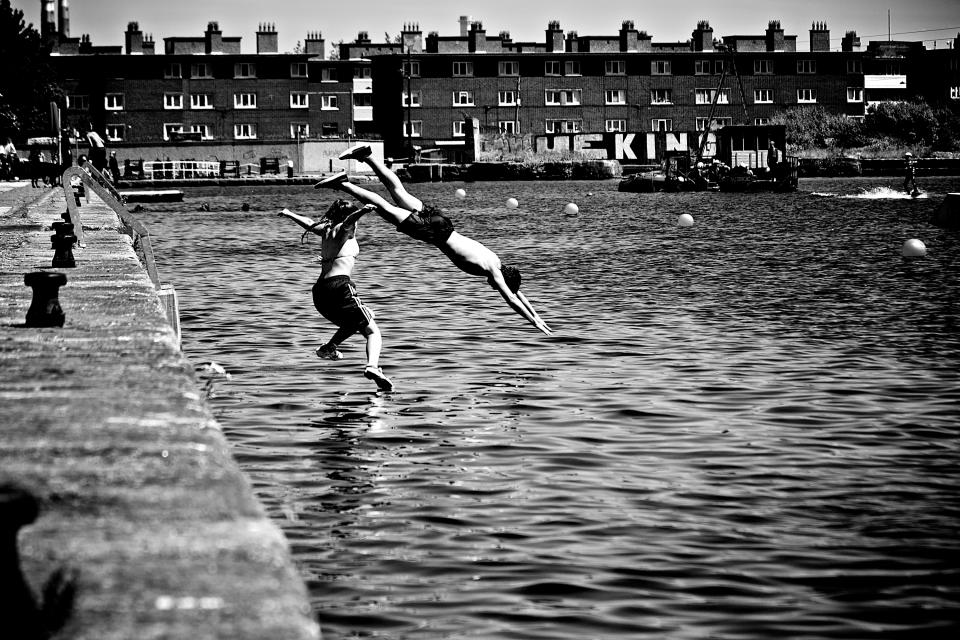 water swimming swandive people girl diving city buildings boy blackandwhite 