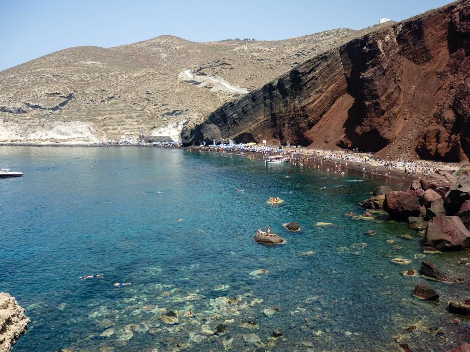 water swimming Santorini sand rocks RedBeach people hills greece crowd cliffs boats 