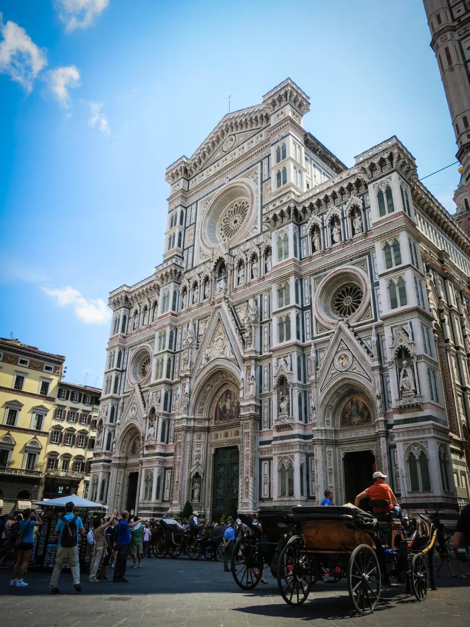 tourists sightseeing SantaCroce photographers people Italy horses Florence carriages building Basilica architecture 