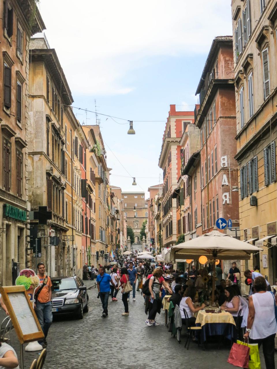 streets Rome restaurants people pedestrians Italy houses eating crowd cobblestone city buildings architecture apartments 
