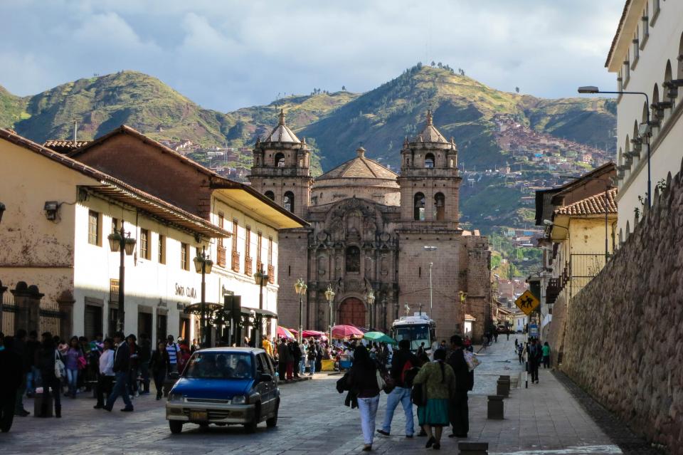 town streets sidewalk peru people pedestrians mountains hills Cusco cobblestone city buildings architecture 
