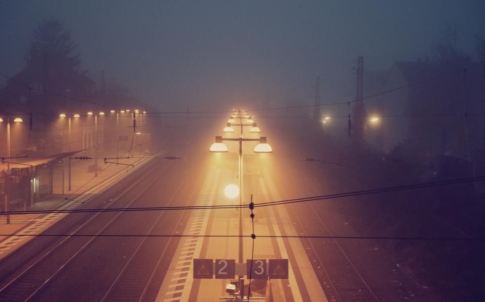traintracks signs railway railroad night mist lights lampposts fog evening dark 