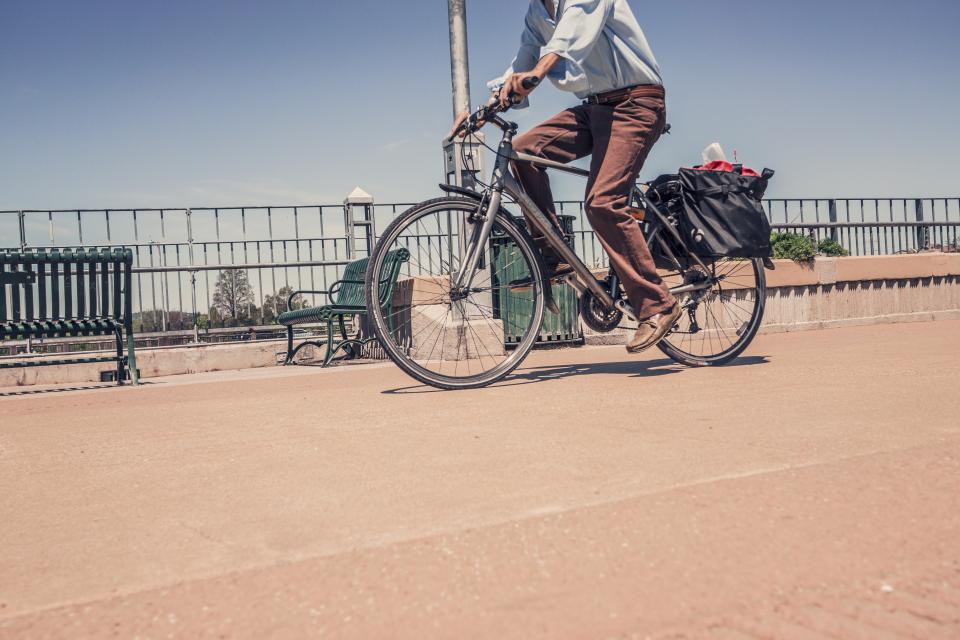 sunshine street shirt road railing pants man guy bike bicycle benches 