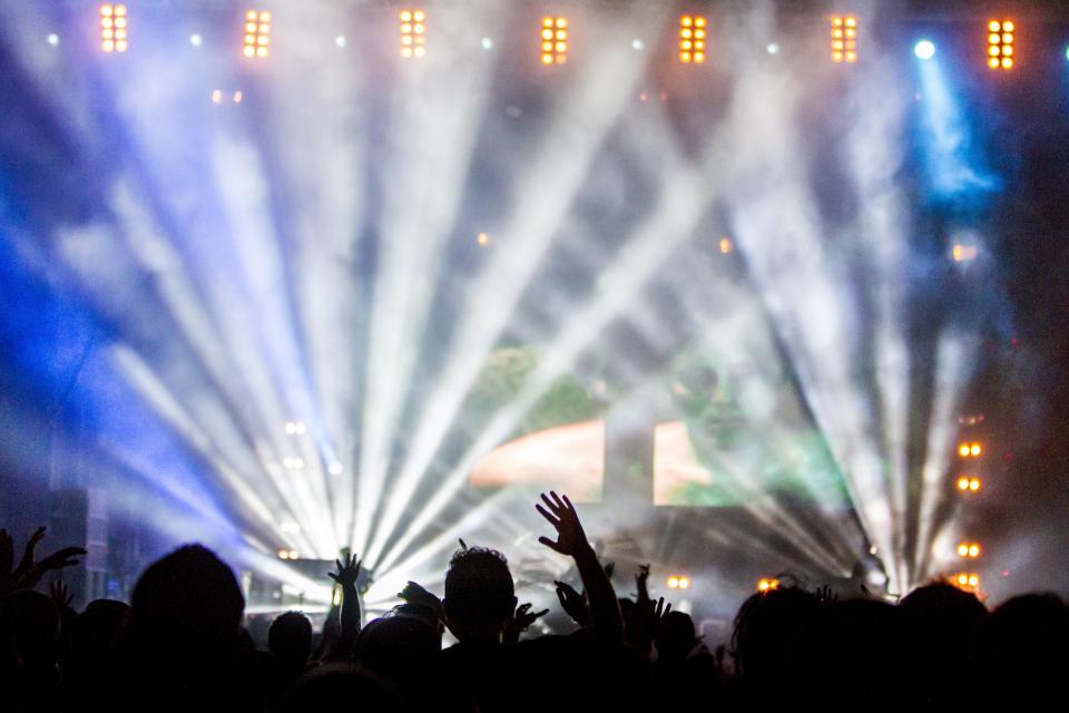 stage smoke screens music lightshow lights hands energy crowd concert 