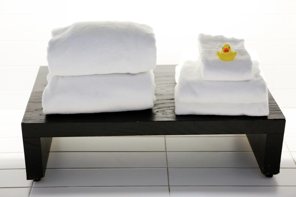 yellow white towels tiles spa rubber duck bench 