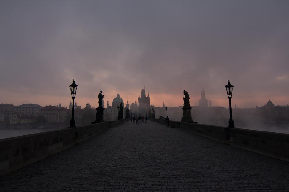 statues lampposts fog dusk dark cobblestone clouds city buildings Bridge architecture 