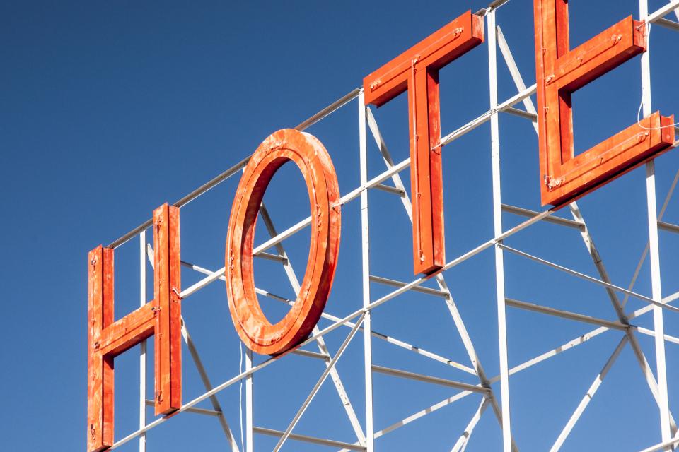 sky sign orange letters hotel blue 