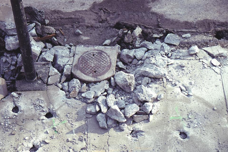 street stones sidewalk sewer rocks post manhole construction concrete 
