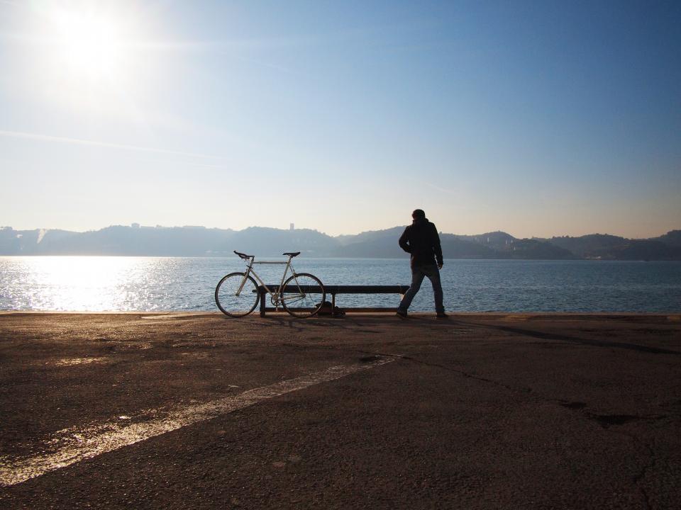 water sunshine sky mountains man guy blue bike bicycle bench 