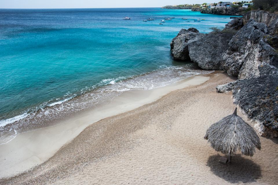 water umbrella tropical sea sand rocks paradise ocean coast Caribbean boats beach 