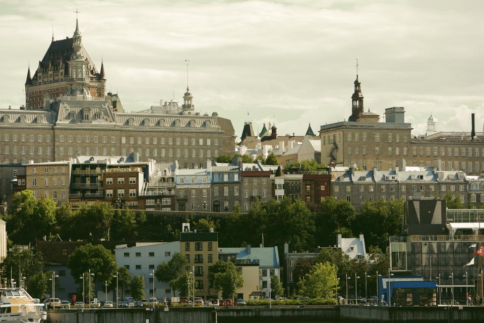 Windows trees rooftops quebec pier lampposts houses cross city castle buildings boats 