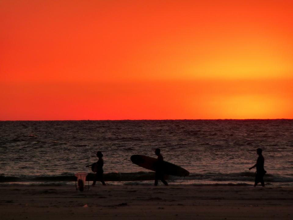 water surfing surfer surfboard sunset summer sky sand red ocean beach 