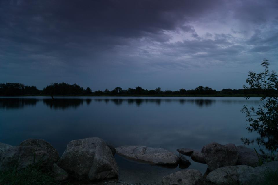 water trees sky rocks night lake dusk dark cloudy clouds 