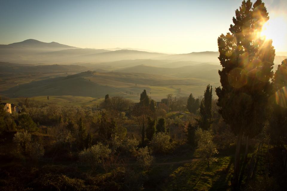 tuscany trees sunshine sunrays sky Italy horizon hills fields 