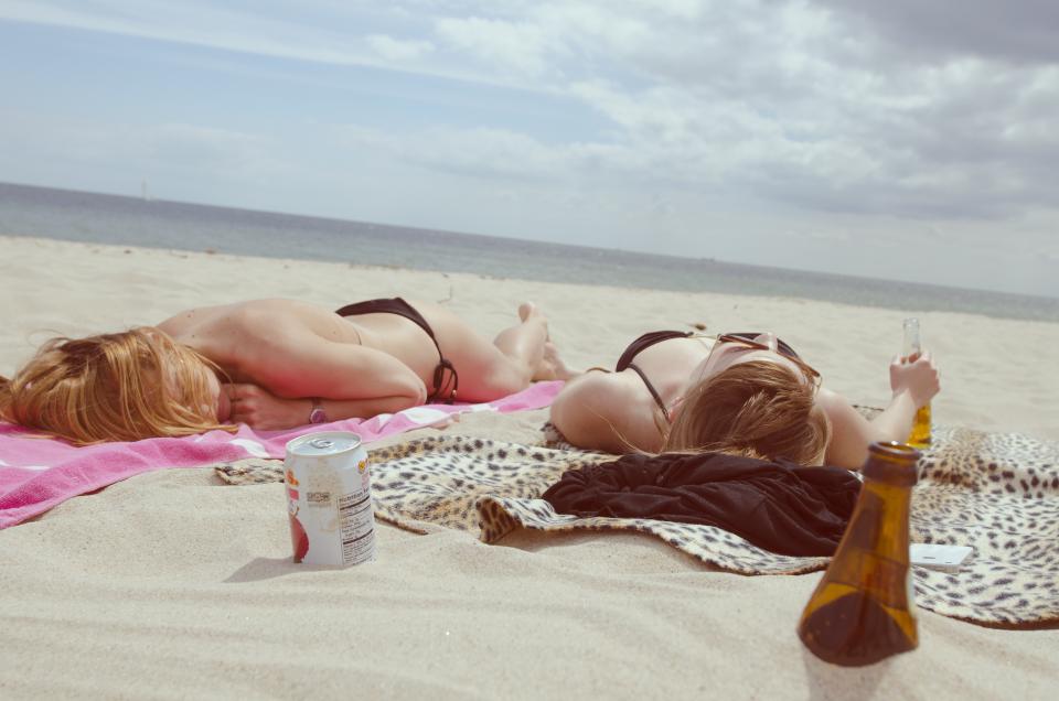 women water towels tanning swimsuit swimming sunglasses sun summer sleeping sky sand people hot girls drinks clouds bottles beer beach bathingsuit 