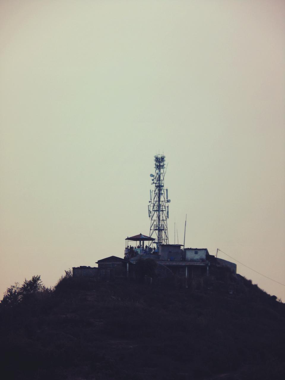 tower sky shacks satelites people huts houses hill 