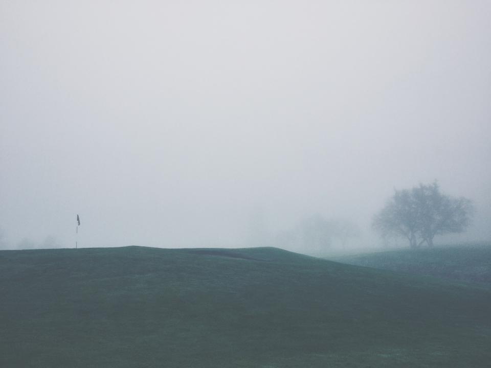 trees sports pin grey green grass golfcourse fog flag fairway 