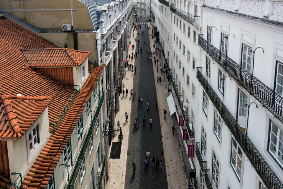 Windows walking street stores shops Portugal people pedestrians lisbon houses buildings architecture apartments 