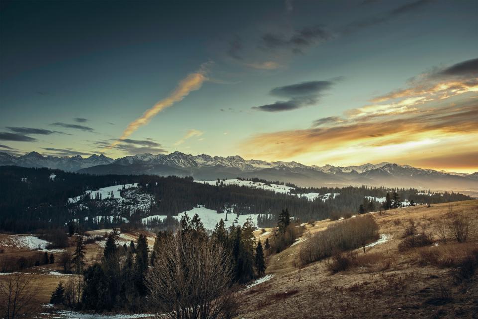 valleys trees sunset snow sky peaks outdoors nature mountains hills fields cold clouds cliffs bushes 