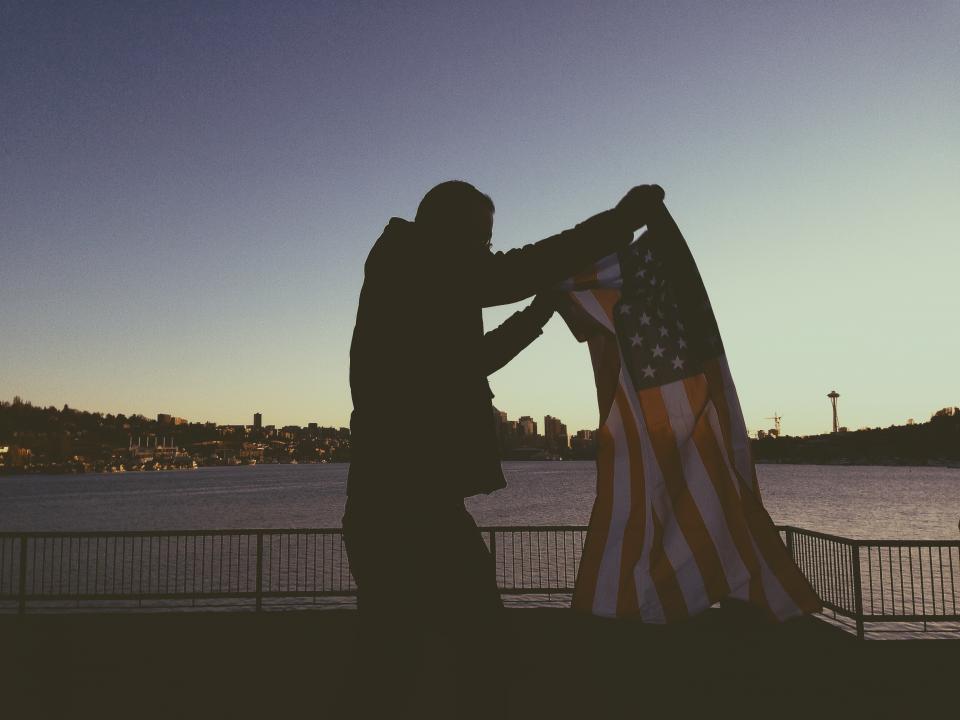 water USA UnitedStates sunset skyline railing man guy flag dusk buildings american 