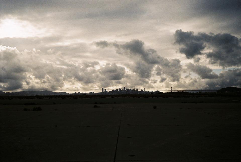 sky, clouds, dark, dusk, silhouette, shadow, city, buildings, skyline, field