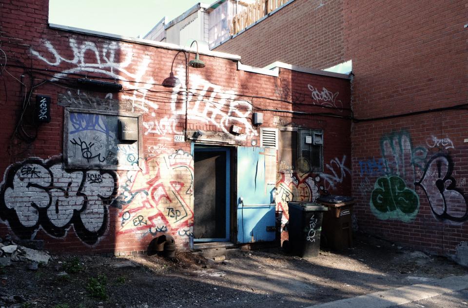 trashcan street spraypaint graffiti garbage dirt bricks backdoor alley 