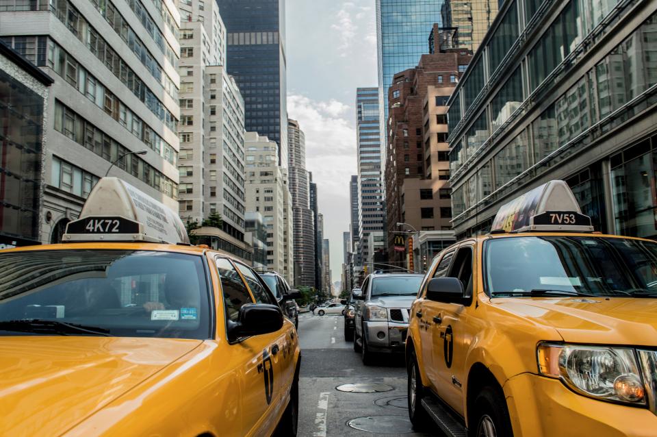 yellow traffic taxis street road NewYork city cars buildings 