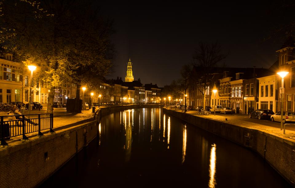 water streets night lights evening dark city cars canal buildings architecture 