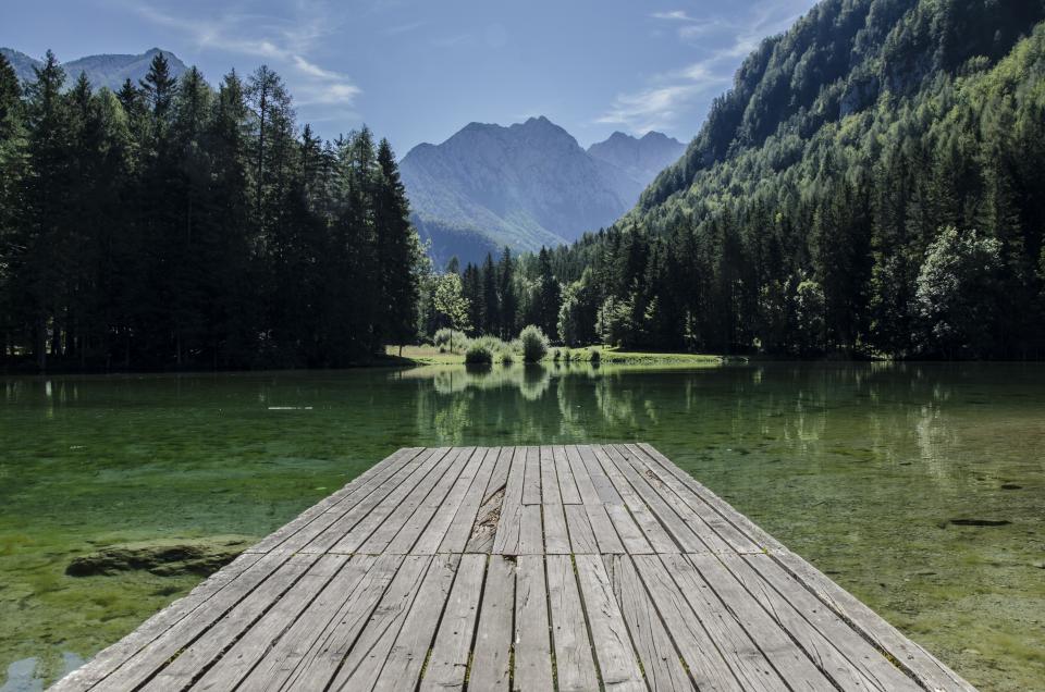 wood water trees sky planks outdoors nature mountains green dock 