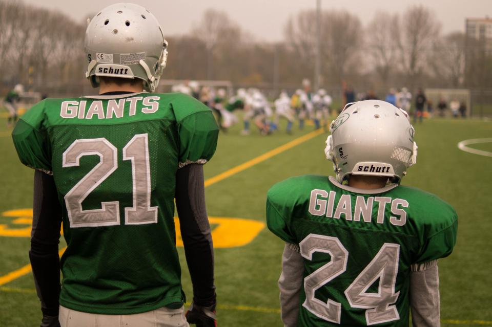 football, teammates, giants, field, sports, athletes, uniform, helmets, green