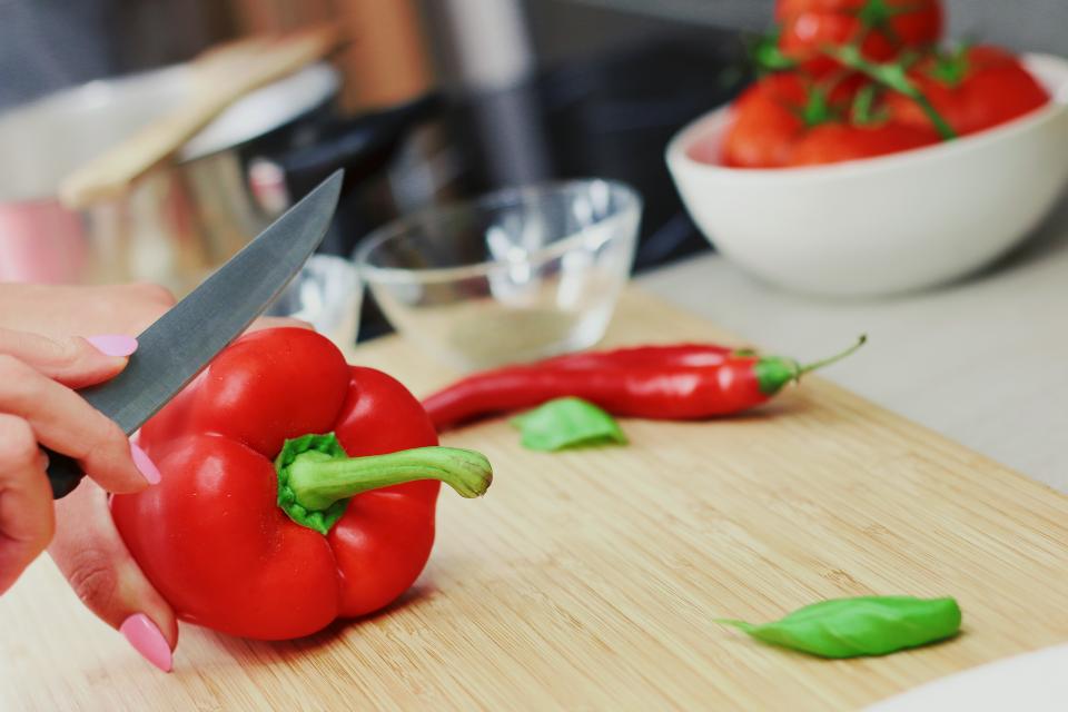 vegetables redpeppers knife kitchen ingredients fingers cuttingboard cooking bowls 