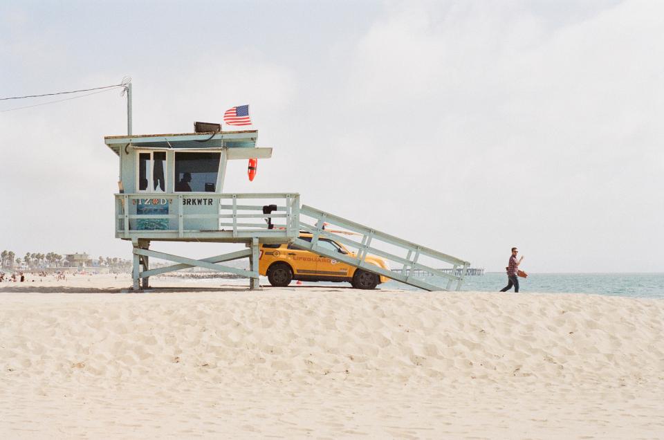 Venice USA truck suv sunshine summer sand ocean man lifeguard flag beach american 