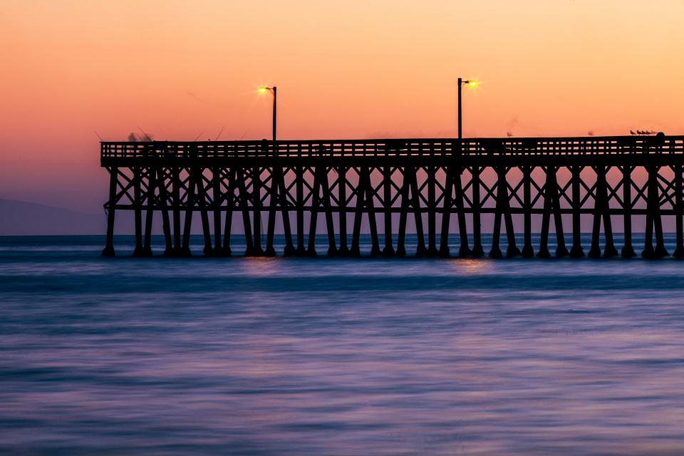 water sunset sea purple pier orange ocean lights lampposts dusk dock beach 