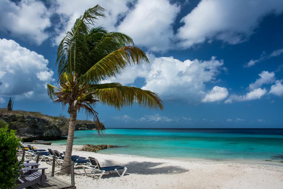 water vacation tropical sunshine sky sea sand paradise palmtree ocean loungechairs coast clouds blue beach 