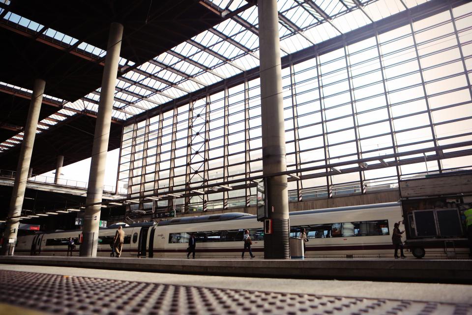 Windows walking travel transportation train tracks sunlight station pillars pedestrian passenger beams 