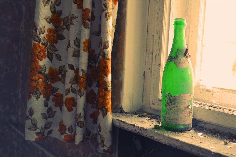 window sill old green Damaged curtains chipped bottle 
