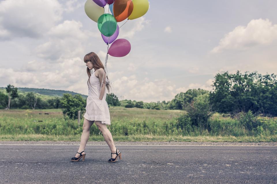 woman walking trees sky road redhead legs highheels hair green grass girl fields dress country clouds balloons 