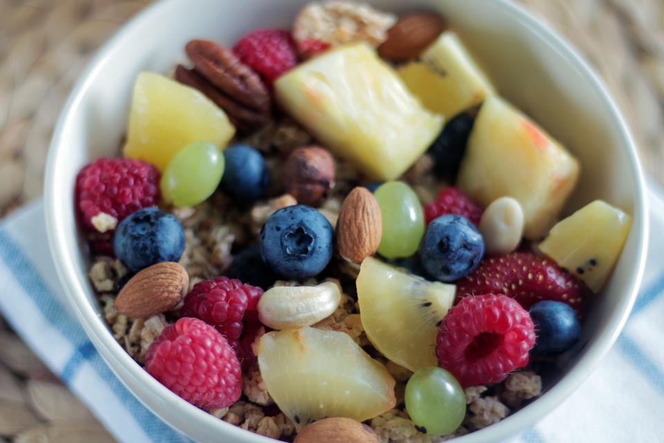 raspberries pineapple nuts Healthy fruits food breakfast bowl blueberries almonds 