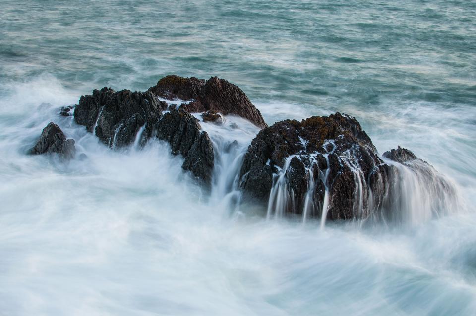 waves sea rocks ocean mist boulders 