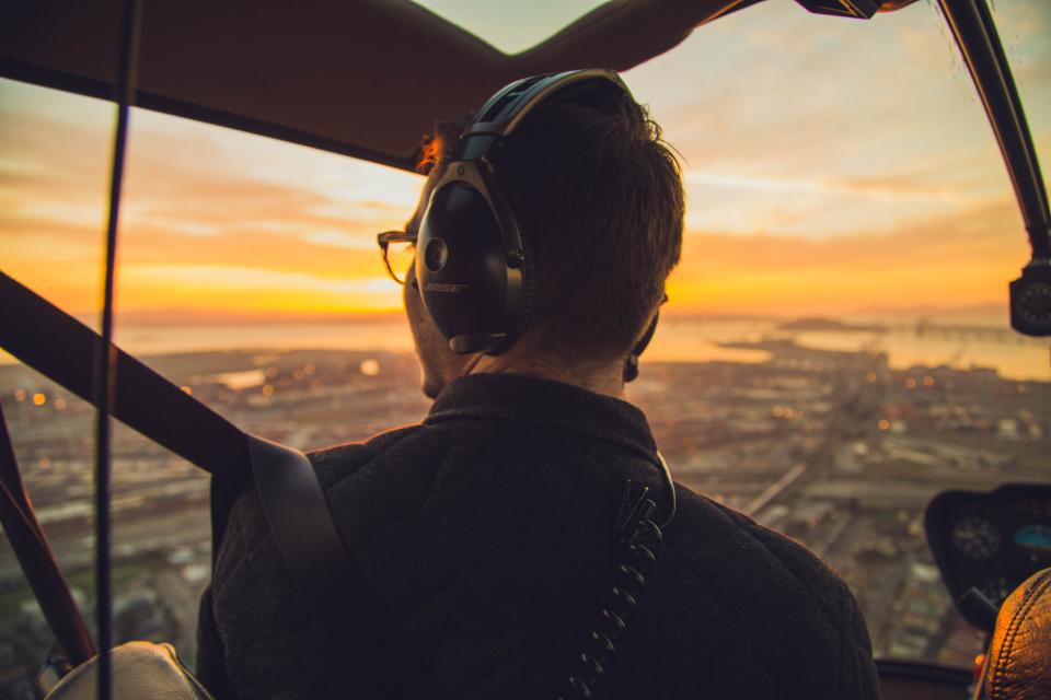sunset pilot helicopter headphones flying flight aerial 