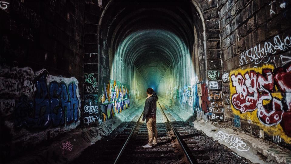 tunnel traintracks railway railroad people night man guy graffiti 
