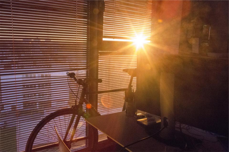 window sunrise sunlight room blinds bike bicycle 